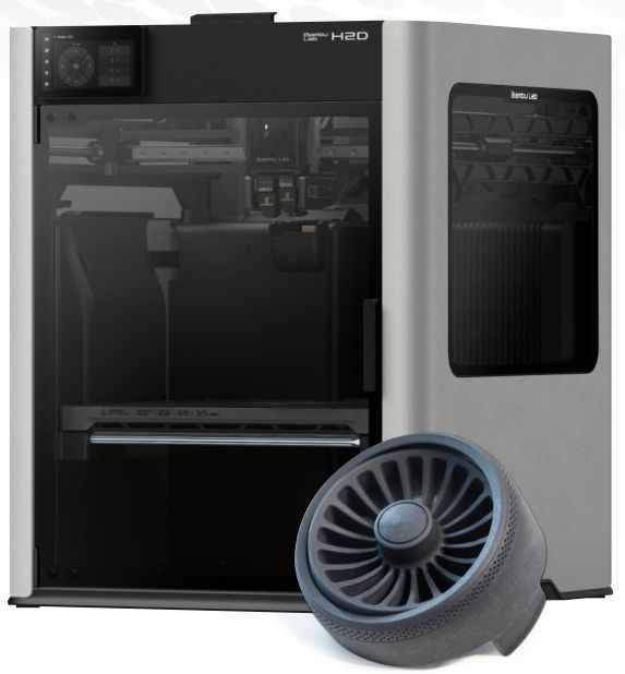 A dual nozzle 3D printer beside a printed fan part
